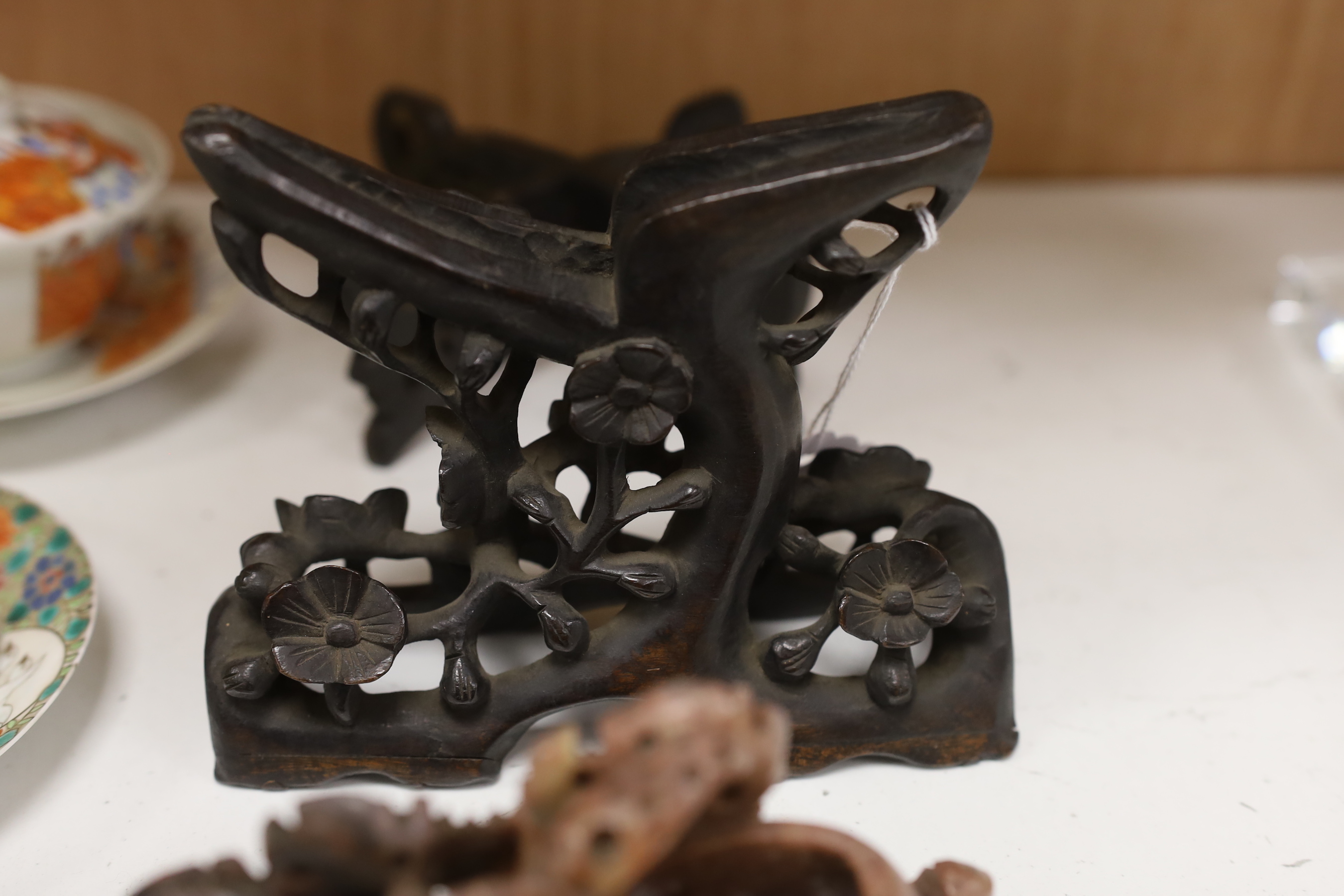 Two Japanese tea bowls one with cover and saucer, a saucer and cover, two Chinese soapstone carvings and four stands